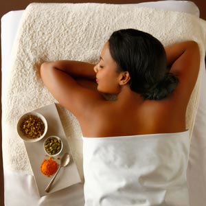 Woman getting a massage with fall ingredients
