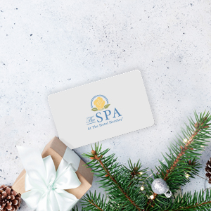 Spa gift card and a gift box and Christmas tree branches